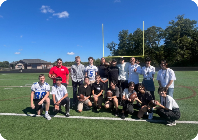 ハイスクールのラグビー場での集合写真